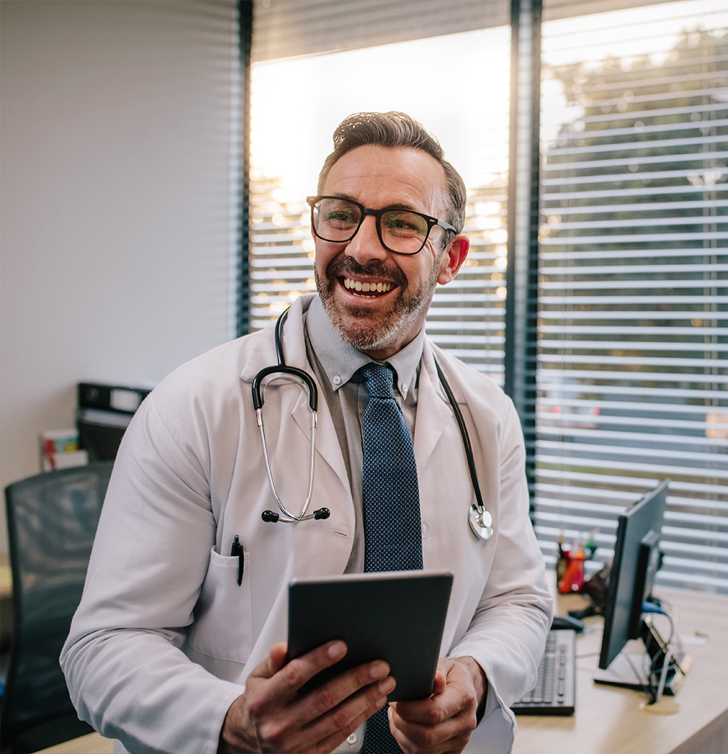 smiling doctor with tablet